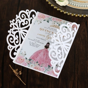 Detail of laser-cut wedding invitation with elegant white shell and pink floral inner page
