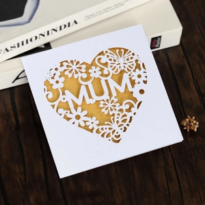 Exquisite laser-cut MUM greeting card with hollow heart pattern on elegant wood background