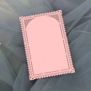 Elegant laser-cut pink lace card with floral hollow pattern on grey mesh background