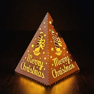 Macro detail of Christmas pyramid night light with hollow star pattern and warm glow