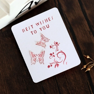 Detailed laser-cut butterfly greeting card with Best Wishes text on a wooden surface
