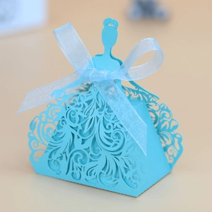 Detail of light blue laser-cut candy box in princess dress shape with ribbon bow