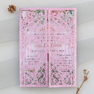 Laser-cut pink glitter wedding invitation featuring intricate floral patterns and insert