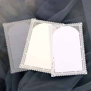 Detailed laser-cut lace decorative cards in three shades on dark tulle background