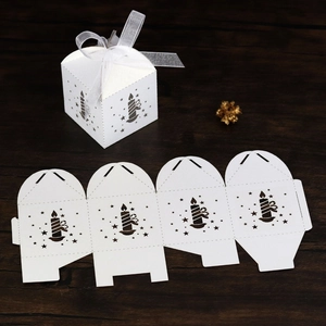 Detailed view of white laser-cut star gift box with ribbon and flat assembly template