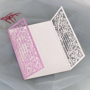 Detail of pink glitter laser-cut butterfly invitation with delicate vine patterns