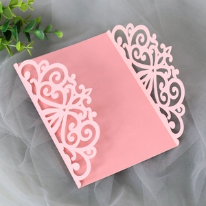 Elegant laser cut pink wedding invitation cover with intricate hollow floral patterns