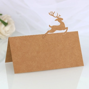 Detail of kraft paper place card featuring a laser-cut reindeer silhouette for tables