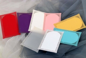 Detailed laser-cut lace cards in multiple colors like pink, cyan and translucent frost