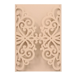 Detailed laser-cut scroll patterns on champagne pearlescent wedding invitation card