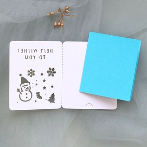 Detailed laser-cut Christmas card with snowman motifs and blue cover on mesh backdrop