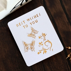 Detailed close-up of 3D laser-cut butterfly greeting card with golden foil text