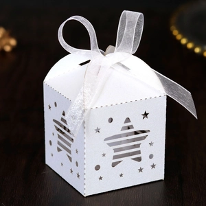 Close-up of white star-shaped hollow gift box with elegant white chiffon ribbon bow