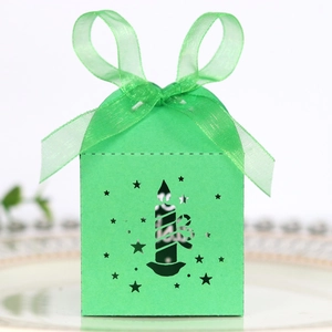 Detailed laser-cut Christmas star and candle patterns on green festive favor box