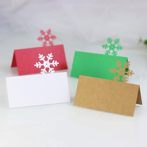 Detail showing colorful laser-cut snowflake place cards for Christmas and winter events