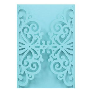 Navy blue laser-cut wedding invitation cover with intricate floral pattern on white background