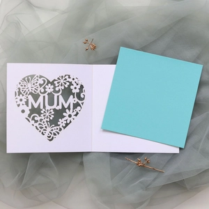 Detail of laser-cut heart pattern and MUM text on premium white Mother's Day card