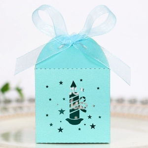 Detail of light blue laser-cut star candy box with a matching organza bow decoration