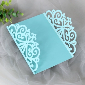 Close-up of laser-cut lace pattern on tiffany blue pearl paper wedding invitation card