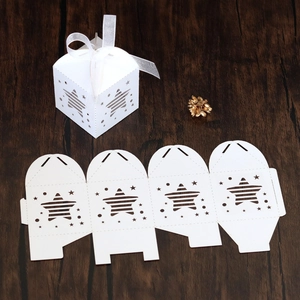 Detailed laser-cut white star gift box with ribbon and assembly template on wood
