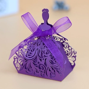 Detail of laser-cut princess dress favor box in purple cardstock with silk ribbon