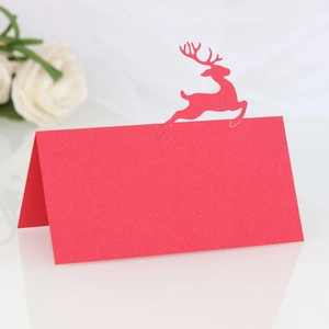 Detailed laser-cut reindeer on red Christmas place card with stand-up folding design