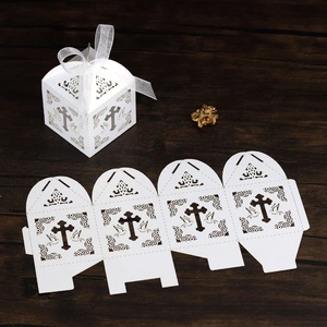 Detail of laser-cut cross and dove patterns on white wedding favor gift box