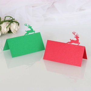 Detailed laser-cut reindeer silhouette on red and green pearlescent paper table cards