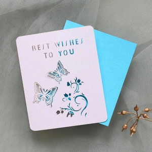 Detail of laser-cut butterfly greeting card with Best Wishes text and blue insert