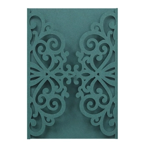 Close-up of laser-cut damask patterns on premium dark green wedding invitation card