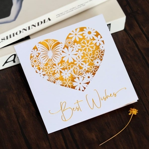 Detailed laser-cut heart pattern with golden butterflies and flowers on a white card