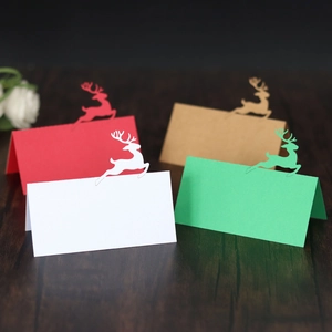 Detailed close-up of hollow reindeer place cards in various colors on wooden table