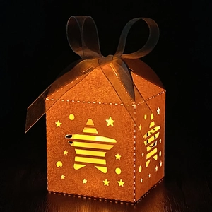 Detail of star-cutout gift box with glitter finish and warm LED light effect