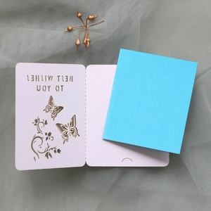 Detail of laser-cut butterfly greeting card with Best Wishes text and blue inner paper