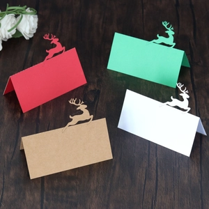 Detailed laser-cut reindeer Christmas place cards in red, green, white, and kraft paper