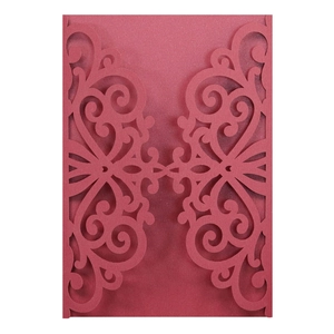 Intricate laser-cut patterns on red pearlescent cardstock for wedding invitations