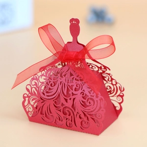 Detail of red laser-cut candy box with bride silhouette and silk ribbon bow