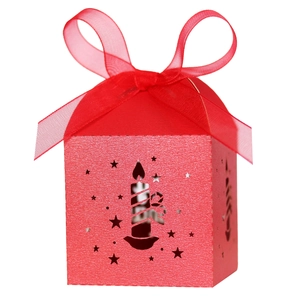 Laser-cut red Christmas candy gift box with candle hollow design and red ribbon bow