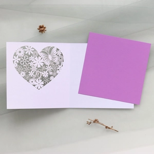 Detail of laser cut butterfly and floral card with elegant purple insert paper
