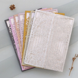 Detailed laser-cut glitter paper wedding invitations in assorted metallic colors
