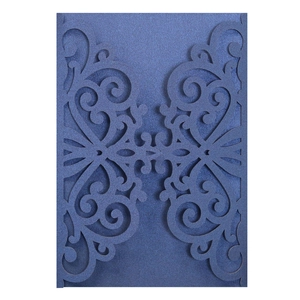 Detail of laser-cut European floral pattern on navy blue pearlescent invitation card