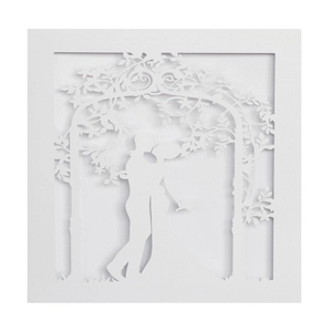 Detailed laser-cut wedding invitation featuring a romantic couple kissing under an archway
