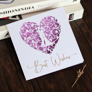 Detail of laser-cut heart pattern greeting card with Best Wishes gold foil text
