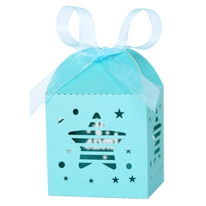 Close-up of light blue laser-cut star pattern gift box with matching silk ribbon bow