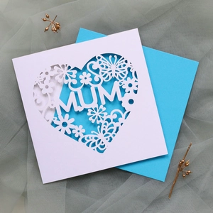 Detailed laser-cut white greeting card with MUM text and blue envelope for Mother's Day