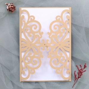 Detail of laser-cut Baroque pattern on camel kraft paper wedding invitation cover