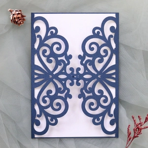 Detail of laser-cut navy blue wedding invitation cover with elegant pearl paper finish