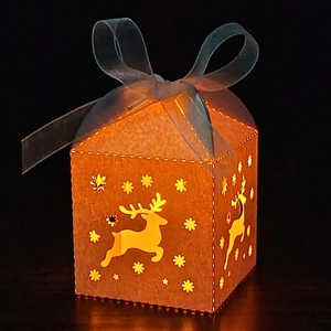 Detail of Christmas reindeer hollow gift box with warm LED lighting and blue ribbon