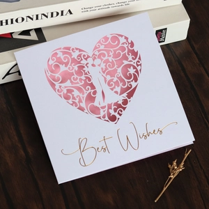 Detail of white square greeting card with laser-cut pink heart and gold Best Wishes text