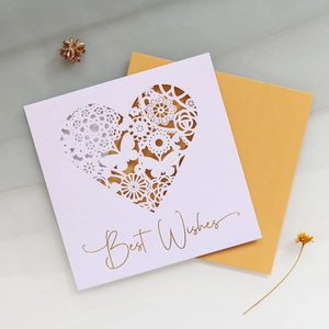 Detail view of laser-cut heart greeting card with Best Wishes gold foil and metallic envelope